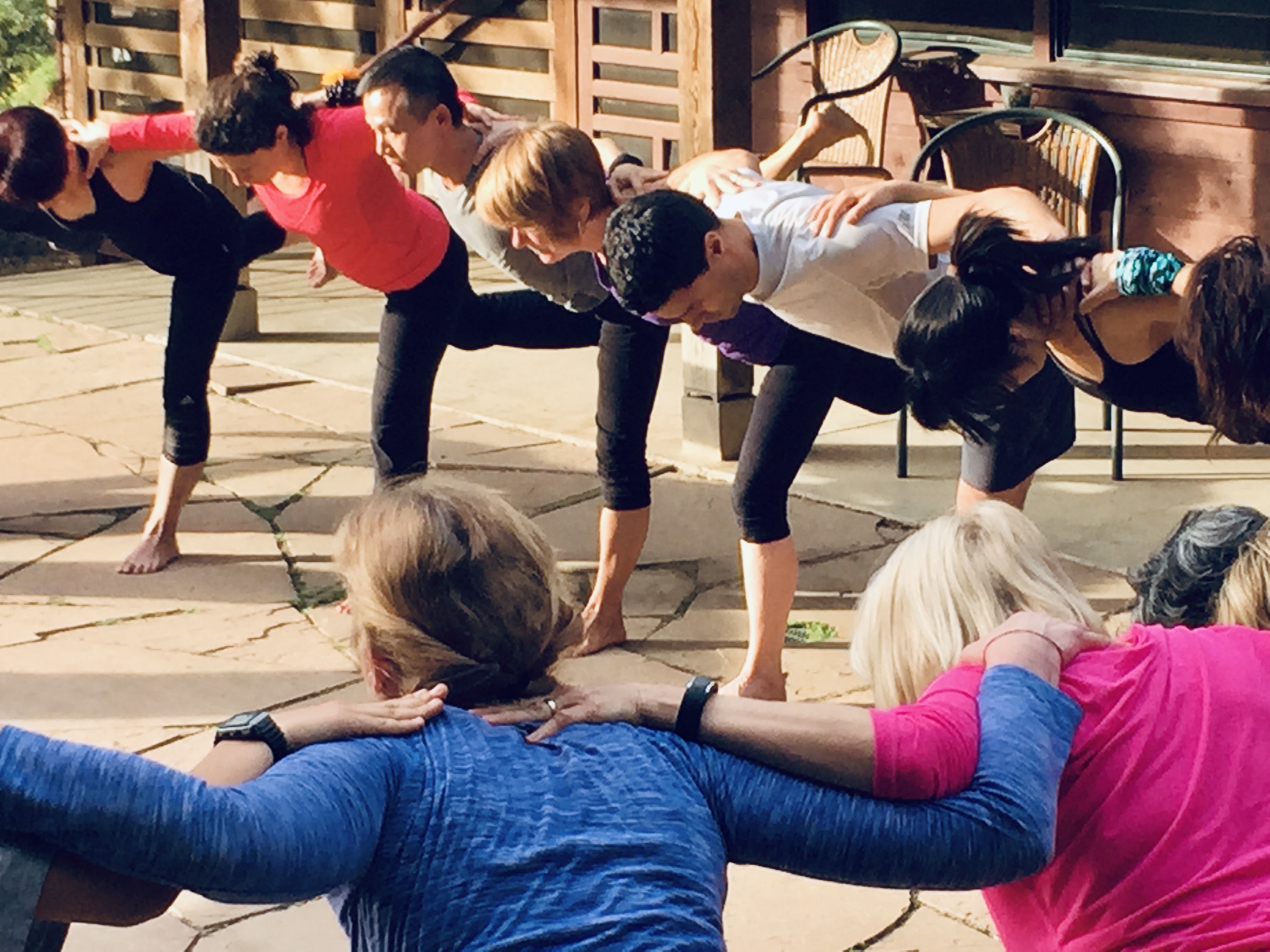 Retreat participants practicing a partner-assisted pose