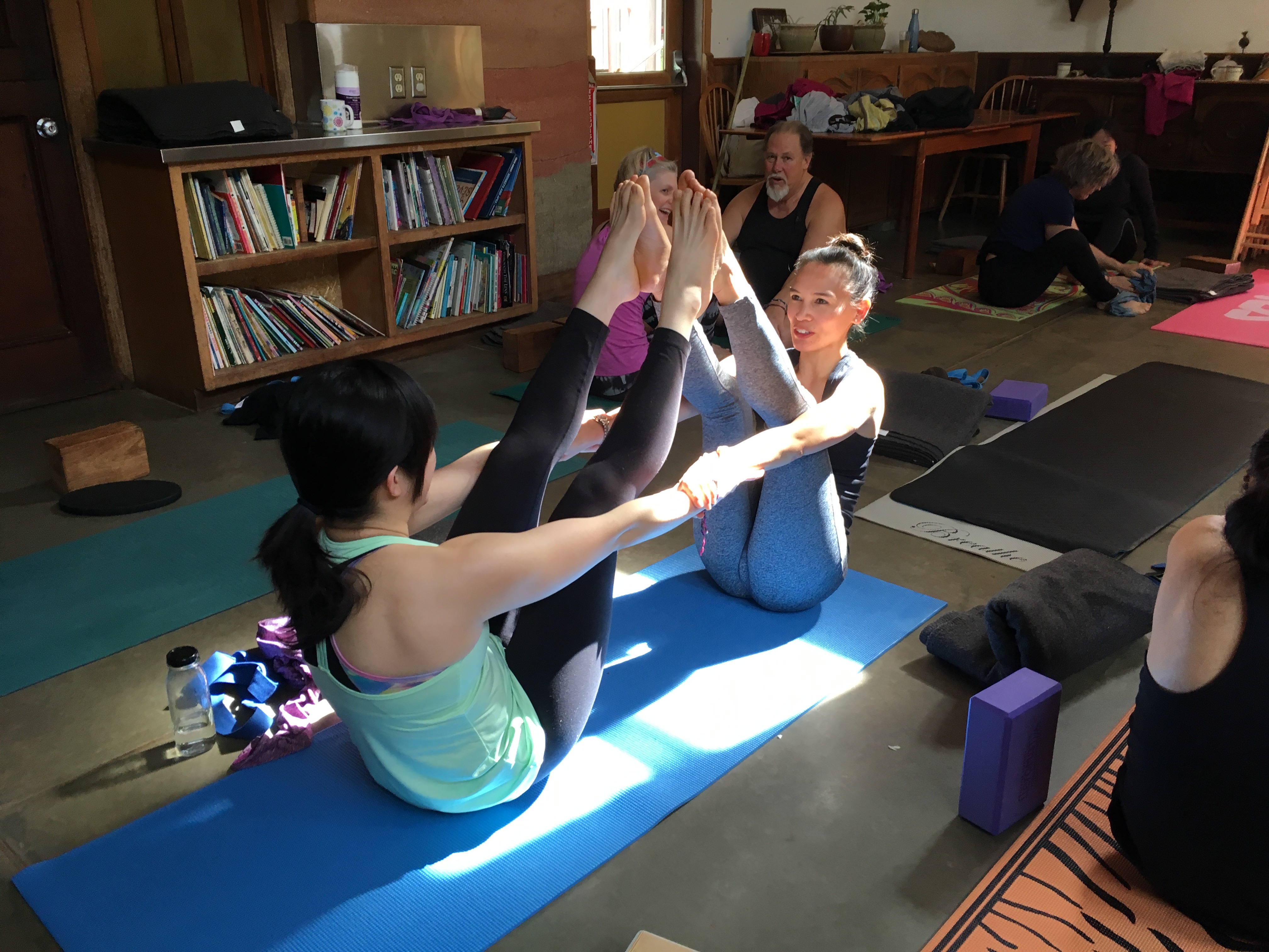 Retreat participants practicing a seated pose indoors